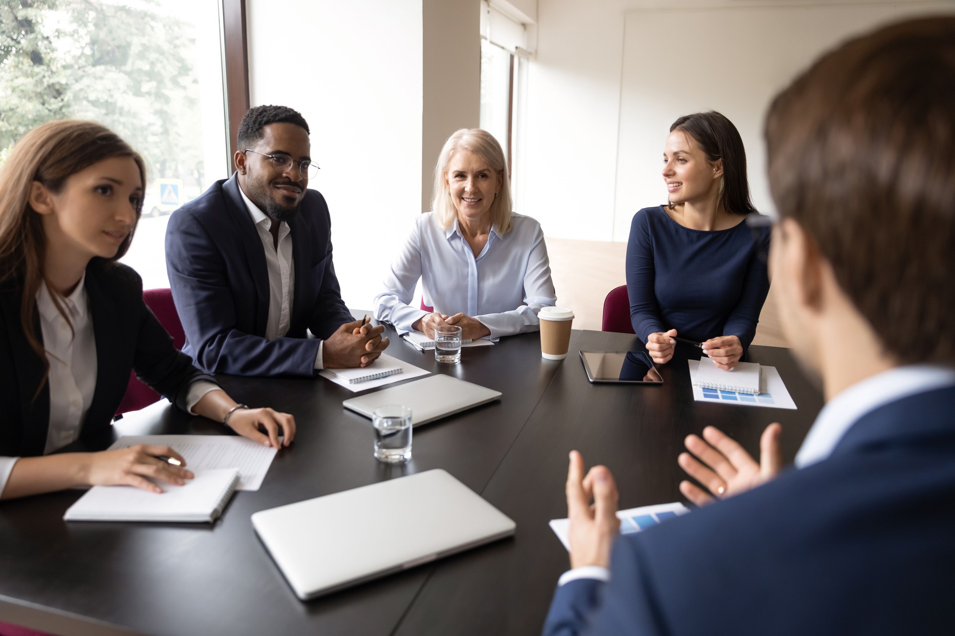 Mentor, coach talking to employees, giving training, discussing marketing reports